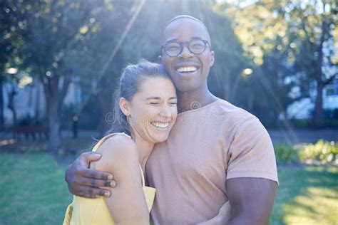 Happy Interracial Couple Hug And Laughing In Joy For Bonding Relationship Together In The Park