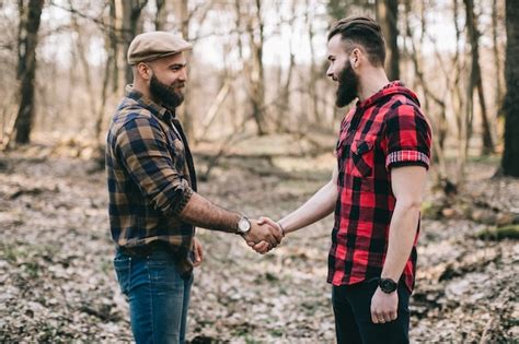 Premium Photo Brutal Men Shaking Hands In Woods