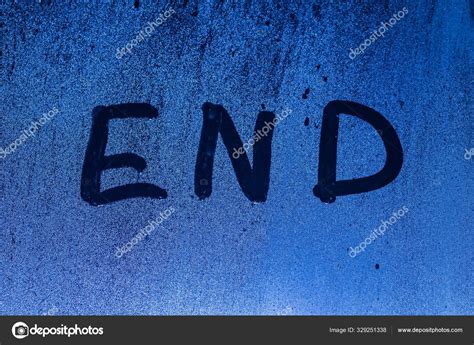 The Word End Written On Night Sweaty Window Glass With Blurred Blue