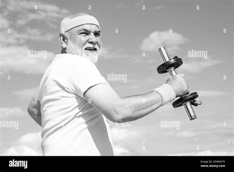 Old Mature Man Exercising With Dumbbell Senior Sportsman In Sport
