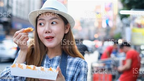 Asian Young Woman Eating Traditional Asian Street Food At Market Bangkok Cityclose Up Of Pretty