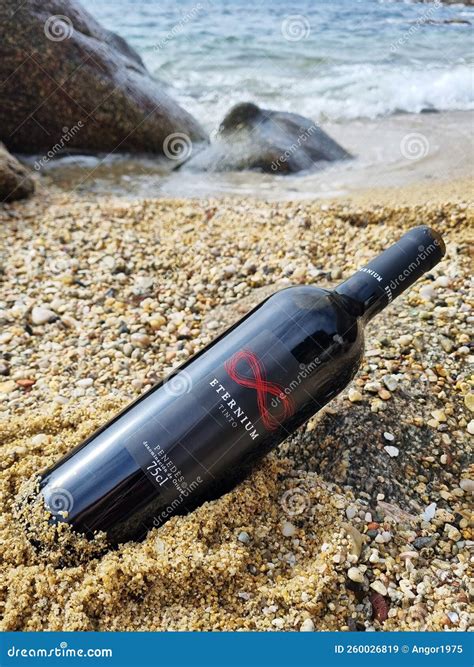 Bottle Of Spanish Wine Eternium On A Sandy Beach In Sea Harbor