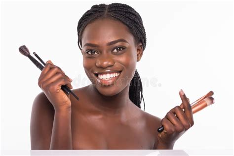 Portrait Of Beautiful African Woman With Makeup Brushes Isolated On White Background Stock Image