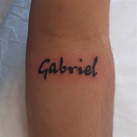 The Word Gabril Is Written In Black Ink On Someone S Left Arm