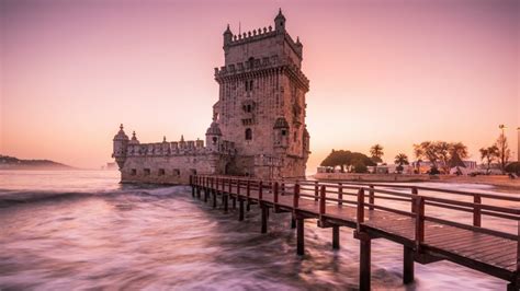 waves bridge castle Torre de Belém palm trees architecture tower