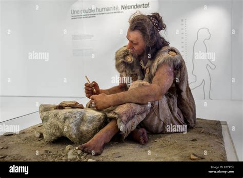 Cro-Magnon man working with stone tools at the Pôle International de la Préhistoire, Les Eyzies ...