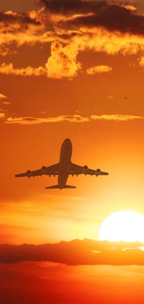 Download A Plane Flying In The Sky Wallpaper