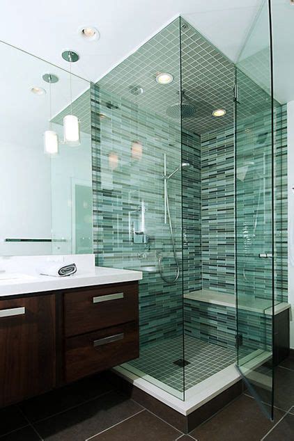 Bathroom Shower With Tinted Green Glass Enclosure Bench Rain Fall Shower Head Surrounded In