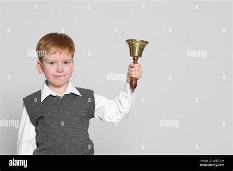 Pupil With School Bell On Light Grey Background Space For Text Stock