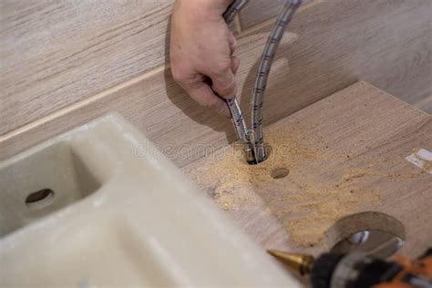 Installing a Bathroom Sink on a Wooden Countertop. Plumbing Work Stock ...