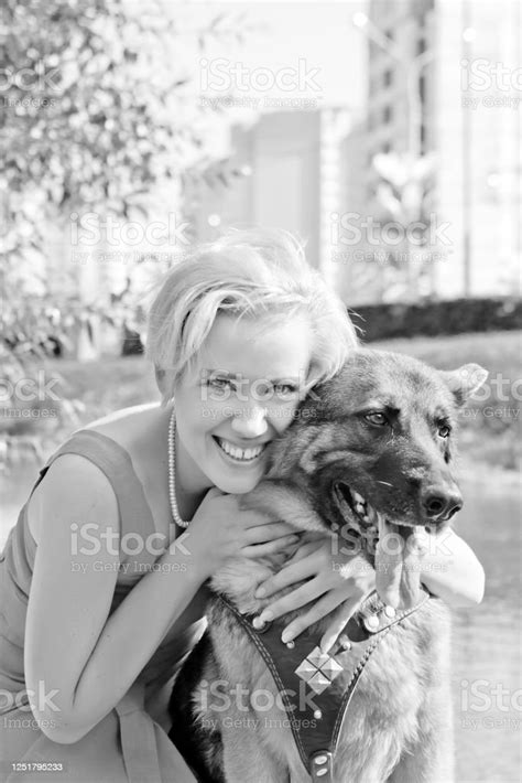 Beautiful Happy Woman Hugs Her Pet German Shepherd Stock Photo