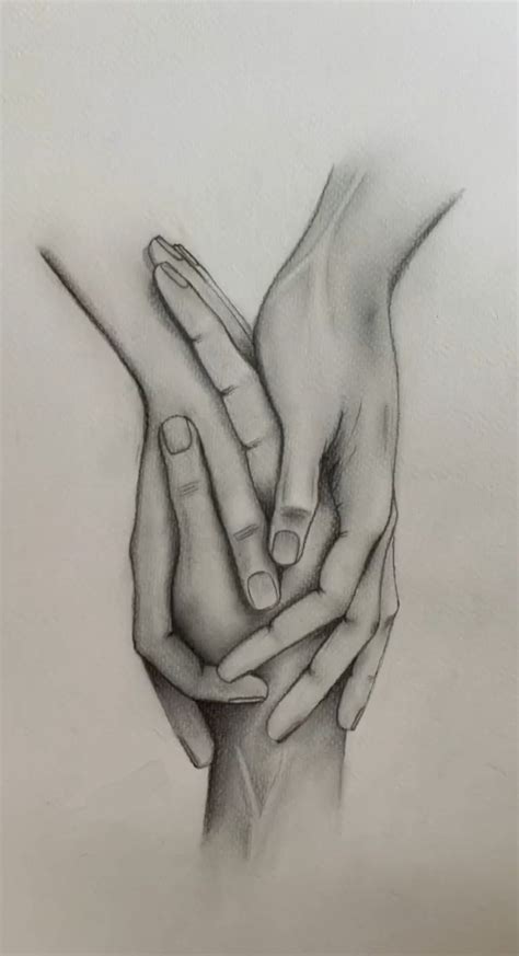 Two Hands Holding Each Other With Their Fingers Touching One Another S