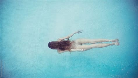 Woman Diving In Swimming Pool By Stocksy Contributor Lumina In