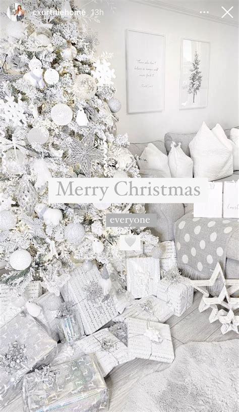 A White Christmas Tree Surrounded By Presents On The Floor And In Front