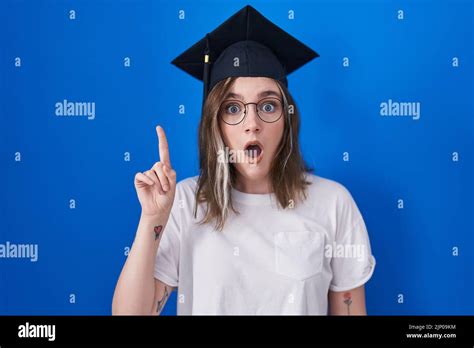 Blonde Caucasian Woman Wearing Graduation Cap Pointing Finger Up With Successful Idea Exited