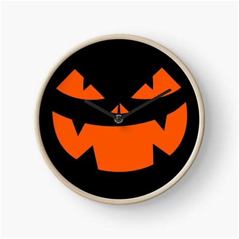 A Clock With An Orange Jack O Lantern Face On The Front And Black