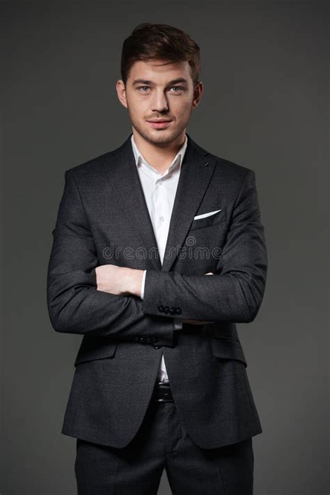 Handsome Confident Businessman In Black Suit Standing With Arms Crossed