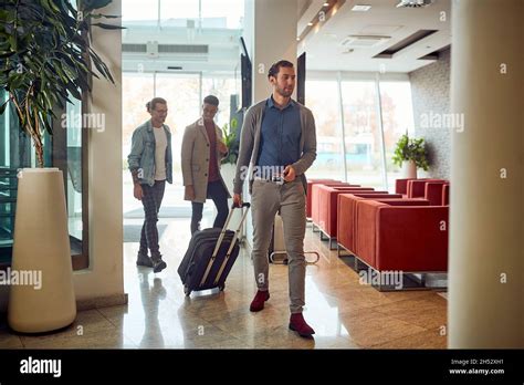 Man Carrying Luggage In The Lobby Of A Hotel Business People With