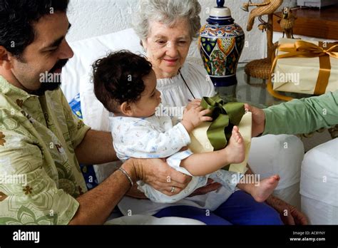 Mature Man Holding His Son And Receiving A Gift Stock Photo Alamy