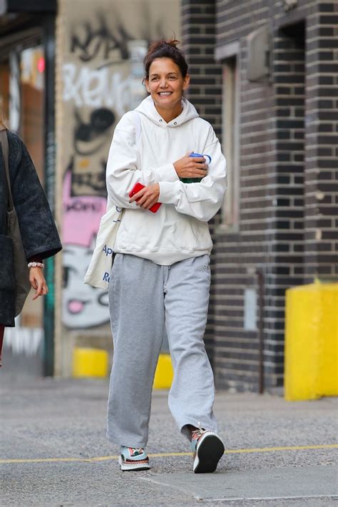 Katie Holmes In Grey Sweatpants A White Sweater And A Pair Of Colorful