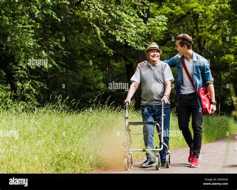 Happy Grandfather Walking With His Grandson In Nature Stock Photo Alamy