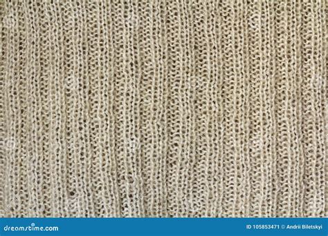 Background Texture Of Beige Pattern Knitted Fabric Made Of Cotton Or