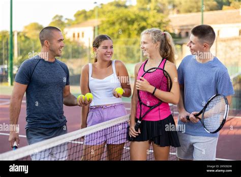 Group Portrait Of Team Of Male And Female Partners Tennis Players