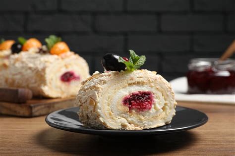 Slice Of Tasty Meringue Roll With Jam Tangerine Slices And Mint Leaves