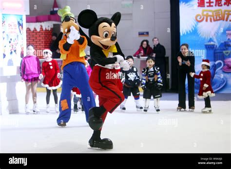 Mickey Mouse And Goofy Skate In Front Of Kids At A Press Conference For