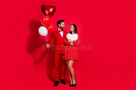 Full Length Photo Of Two Lovely Partners Hold Balloons Heart Figure Pillow Look Each Other Empty