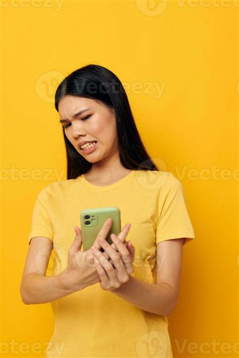 Woman With Asian Appearance Talking On The Phone Posing Technology