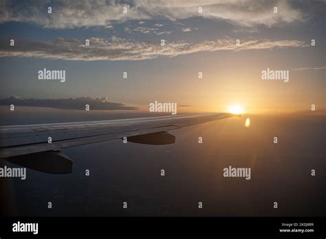 Airplane Flight At Sunset Or Dawn Aircraft S Wing And Land Seen