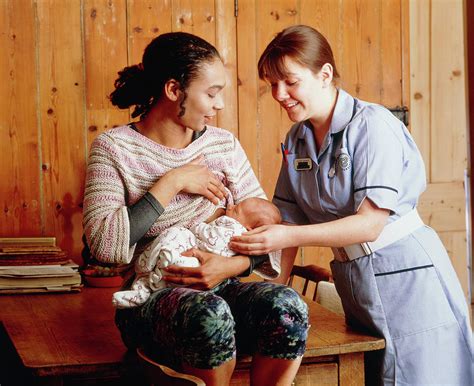 Midwife Helps Mother To Establish Breastfeeding Photograph By Ruth