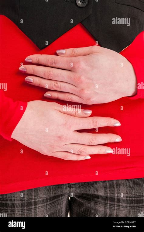 Frontal Close Up Of Two Hands Of A Young Unrecognizable Woman In A Red