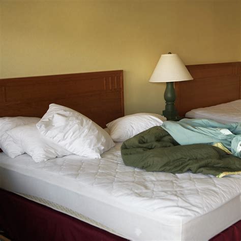 Empty Unmade Bed In A Hotel Room Photograph By Ron Koeberer Pixels