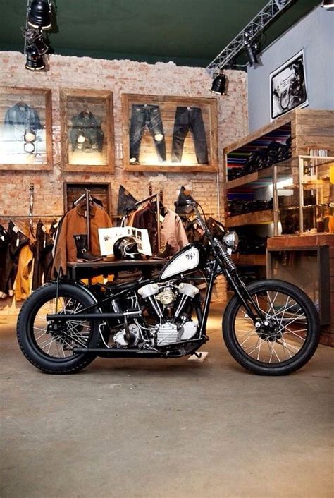 A Motorcycle Parked Inside Of A Shop Next To Some Shelves Filled With