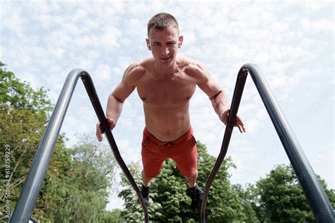 From Below Of Shirtless Muscular Male Athlete With Naked Torso Doing