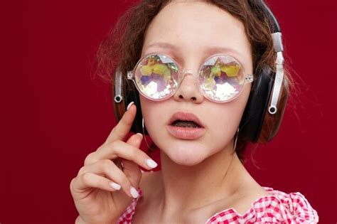 Premium Photo Portrait Of Young Woman Wearing Sunglasses Against Yellow Background