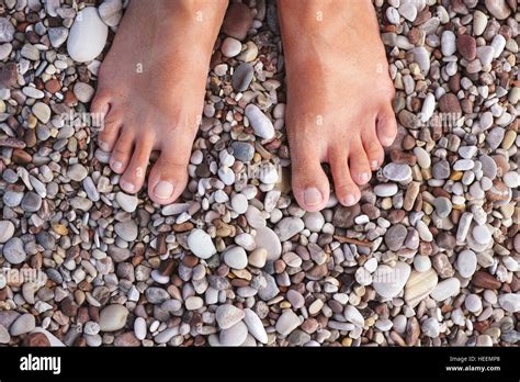 Barefoot Woman Standing On The Pebbles Or Stones Relaxation And