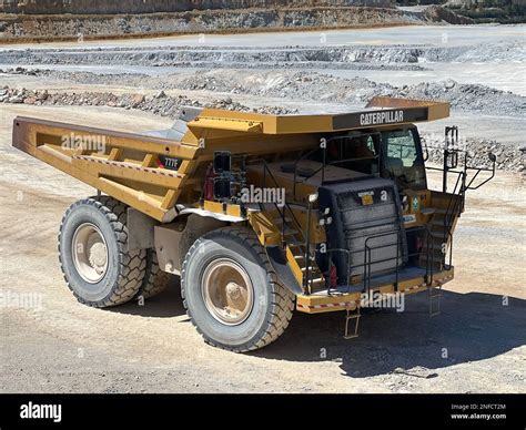 Large Quarry Dump Truck Full Of Stones Transporting The Ore Into The