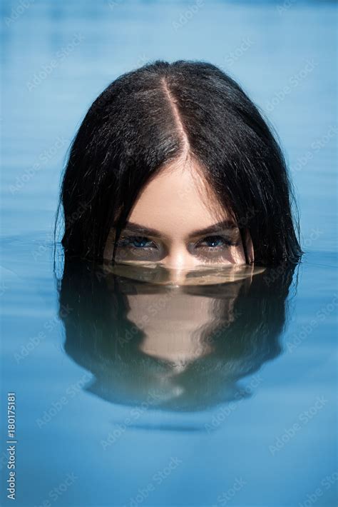 A Sexy Woman Or Girl Floating In The Water Only The Eyes Are Visible