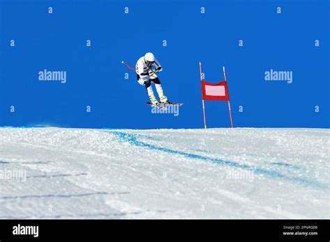 Male Ski Racer On Alpine Skiing Track Downhill Race Jump And Flying On