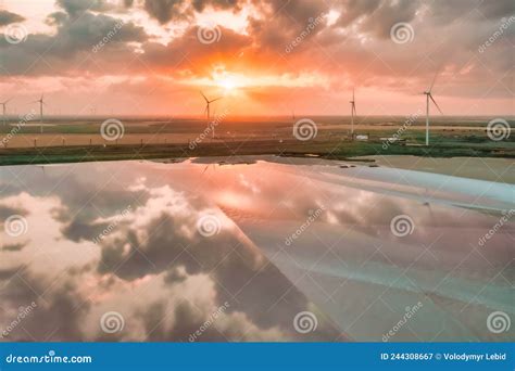 Amazing Aerial View Of A Wind Turbine Near A Pink Lake At Sunset Beautiful Landscape Juicy