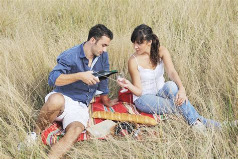 happy couple enjoying countryside picnic in long grass 12644271 Stock ...