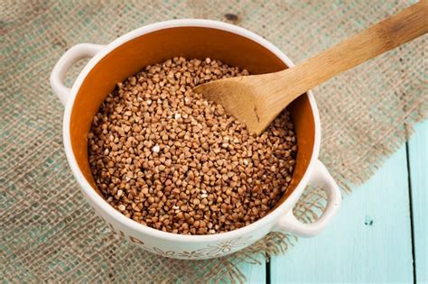 Premium Photo Buckwheat Groats In A Bowl And Wooden Scoop