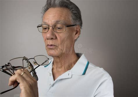 Mature Man Checking Out All His Old Eyeglasses Stock Image Image Of