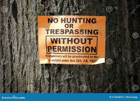 A No Hunting Or Trespassing Sign Posted On A Tree Stock Photo Image