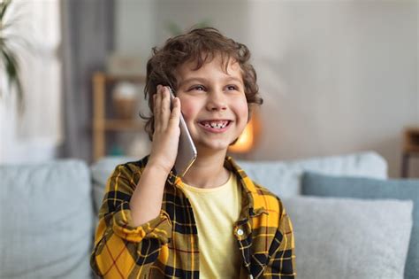 Premium Photo | Close up portrait of happy little boy talking with friends via smartphone ...