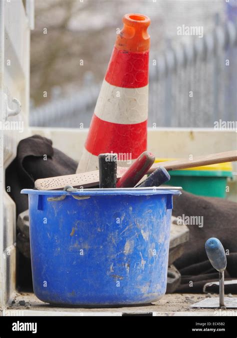 Orange Traffic Cone On Road With Bucket And Tools Stock Photo Alamy