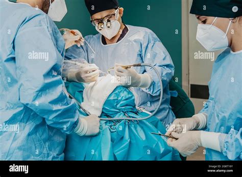 Medical Workers Performing Surgery Inside Operation Room At Hospital